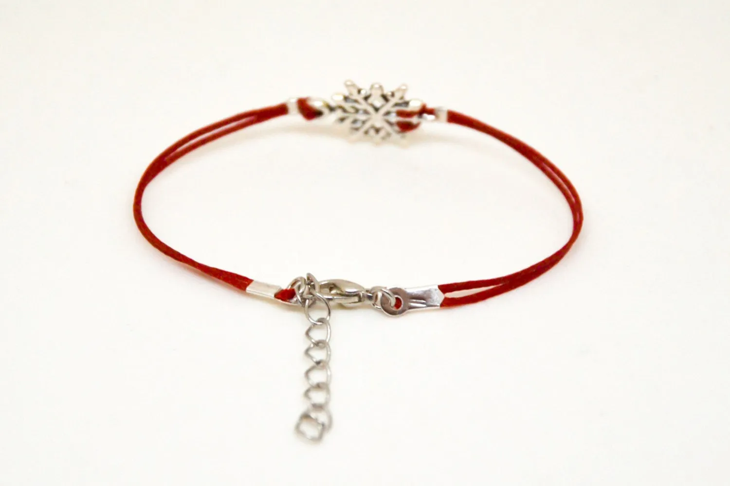 Women bracelet with silver snow flake charm, red cord