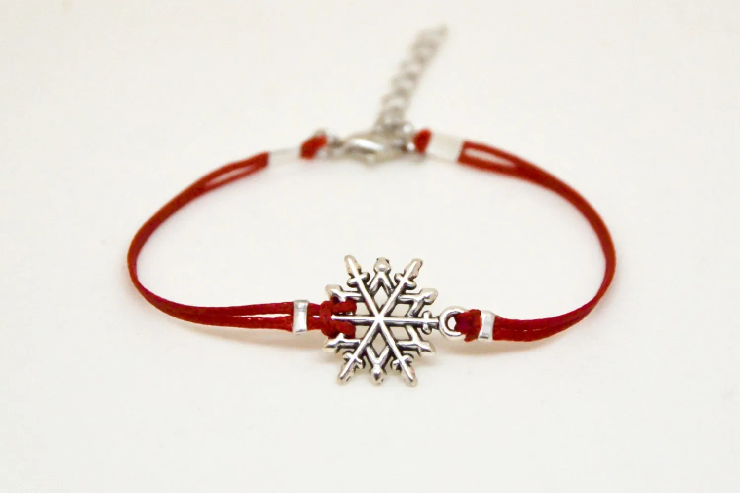 Women bracelet with silver snow flake charm, red cord
